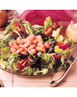A pile of freshly cooked wild pink shrimp, on a green salad