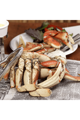 Fresh Dungeness Crab Sections displayed on a clean surface.