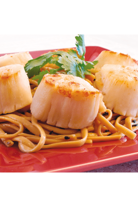 A pile of jumbo sea scallops, fresh and ready to be cooked.