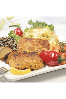 Two Dungeness crab cakes served on a white plate, garnished with fresh herbs and lemon slices.