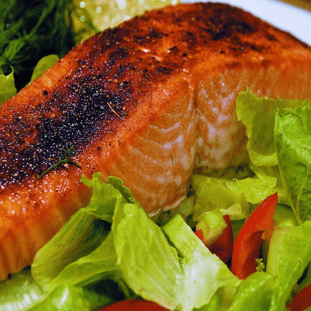 Fresh King Salmon fillets displayed on a clean, white surface.