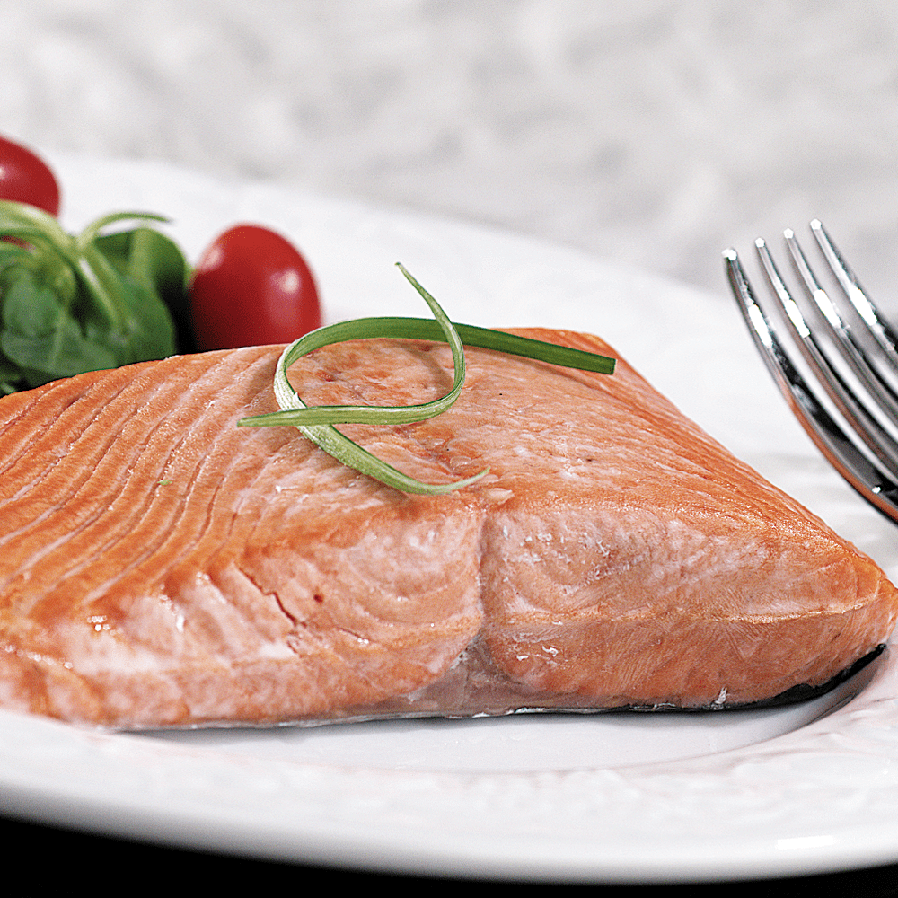 Freshly packed Silver Salmon fillets displayed on a clean surface.
