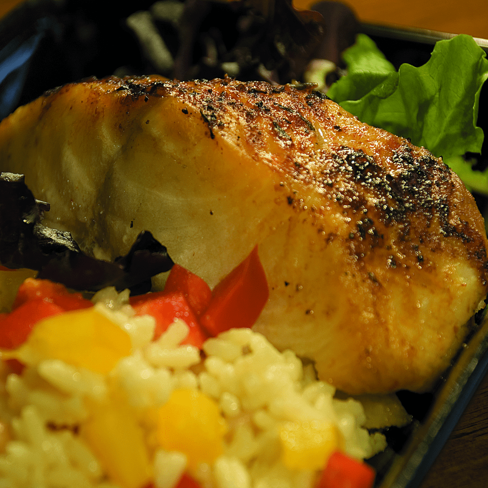 A fresh Black Cod fish displayed on a clean surface.